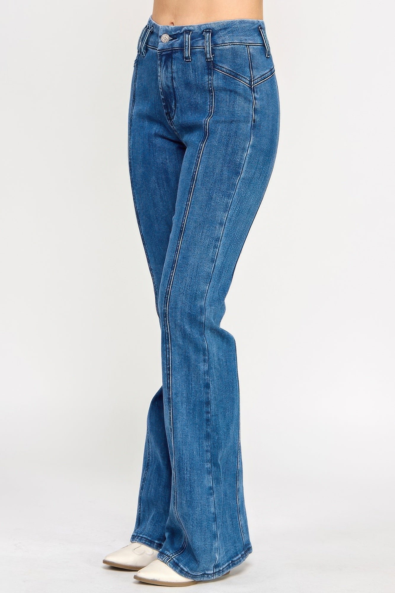 Blue bell-bottom jeans, curved thigh seam and flare leg