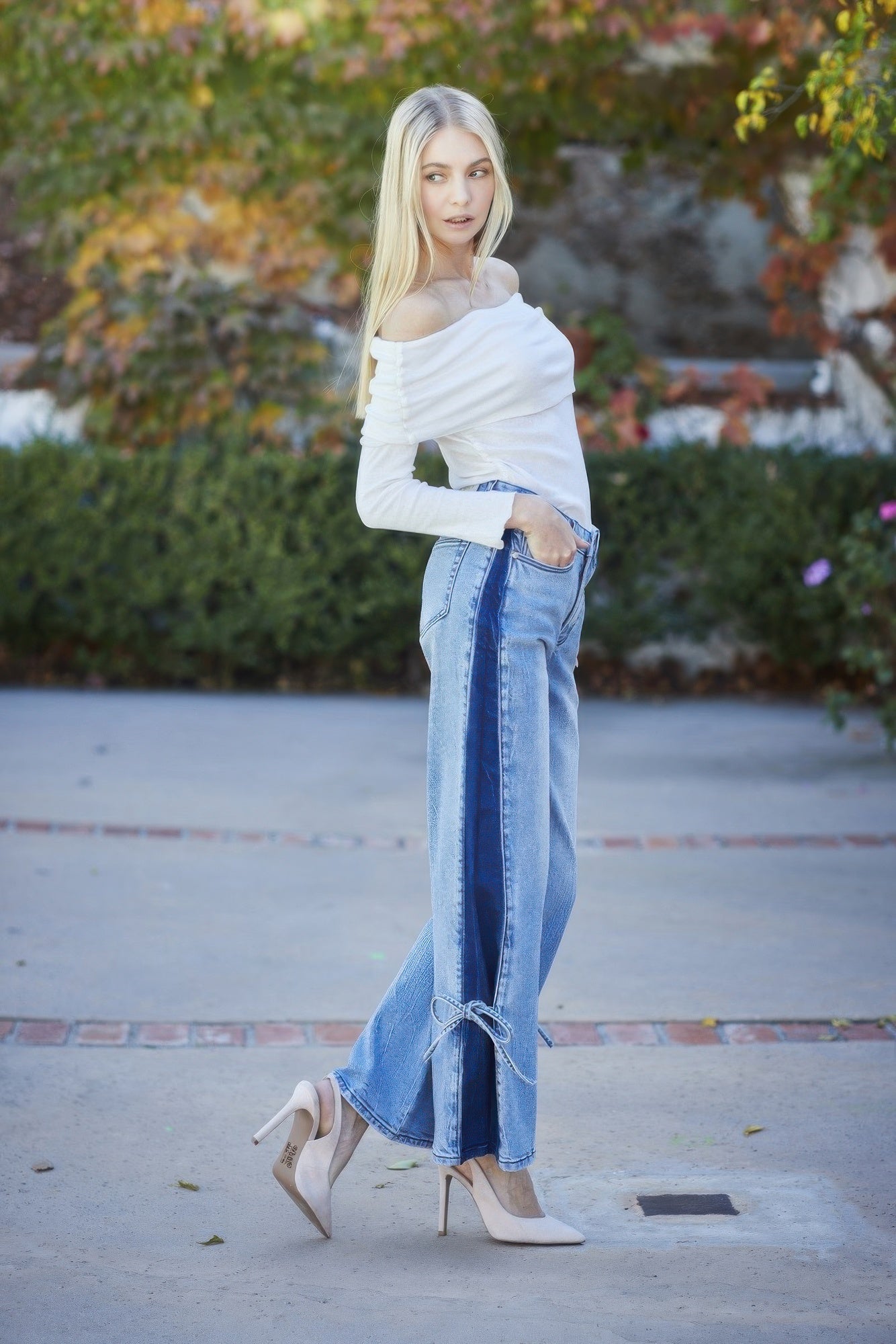 High-rise wide-leg jeans with contrast paneling and ribbon-tie details at the flared hem