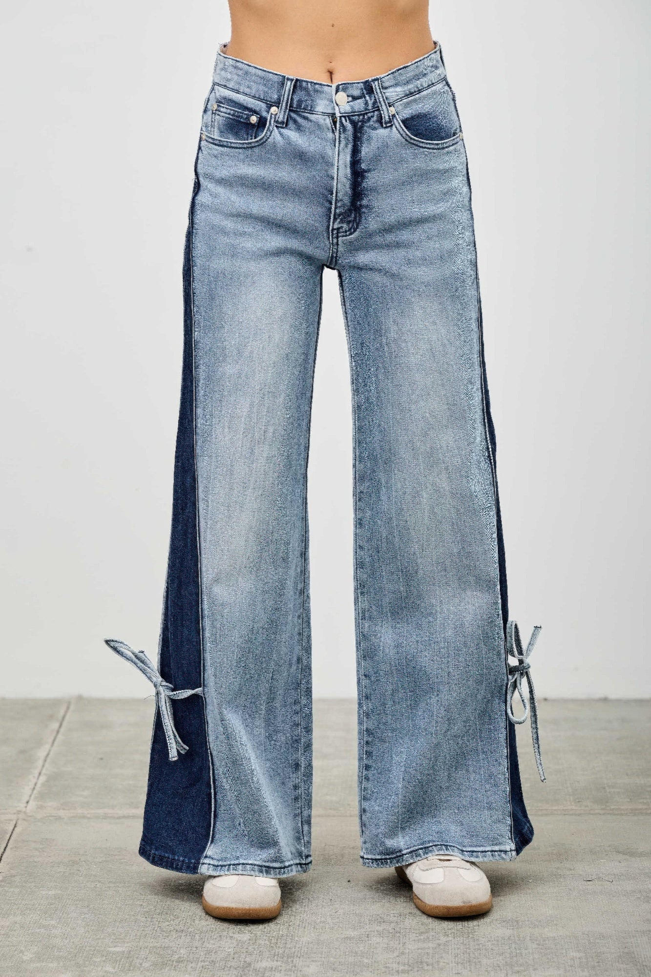 High-rise wide-leg denim pants with contrast side panel and ribbon-tie details