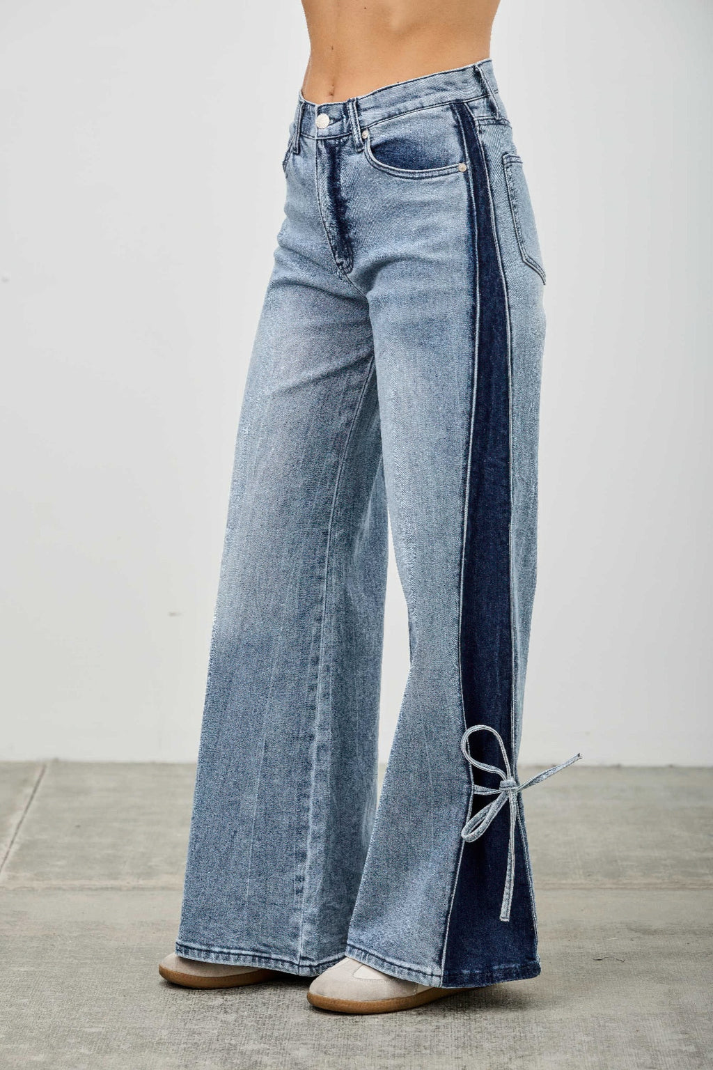 High-rise wide-leg jeans with long contrast panel and ribbon-tie front hem