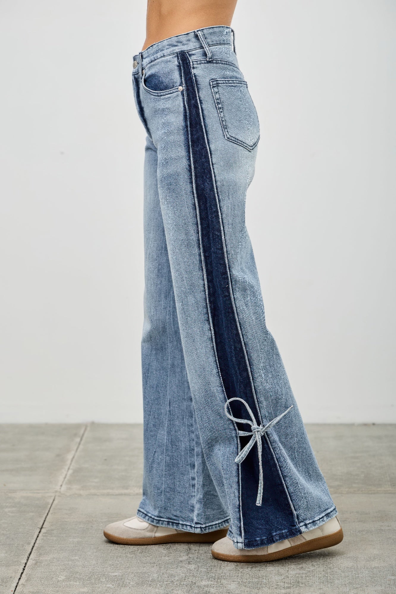 High-rise wide-leg jeans with contrast stripe and ribbon-tie hem near flare