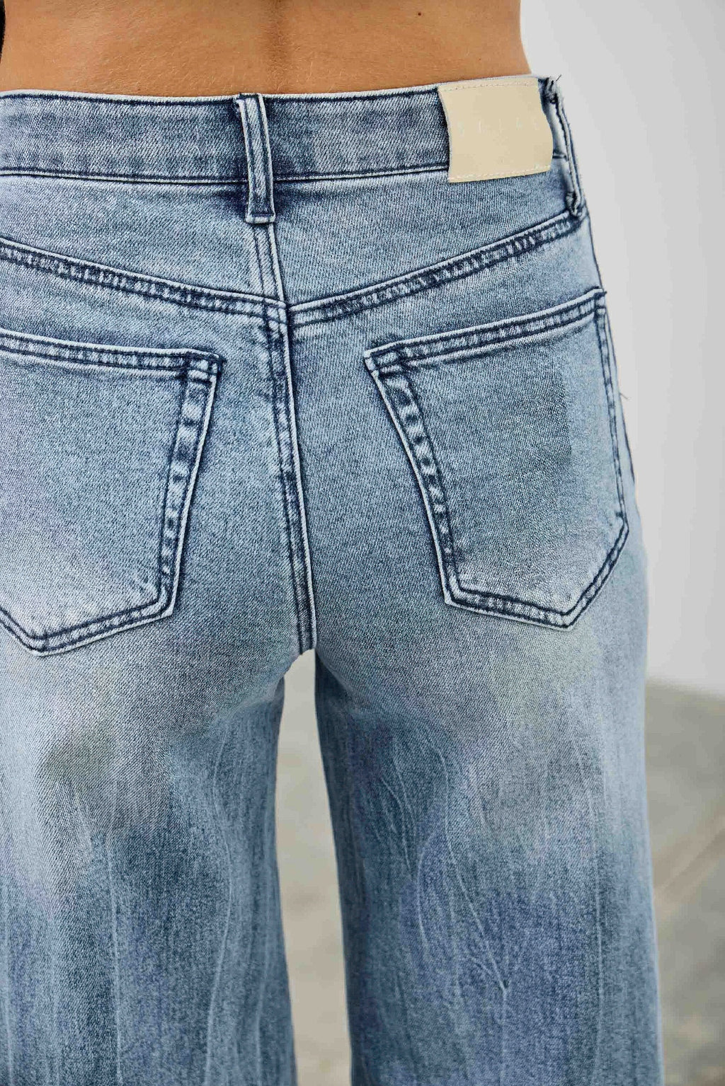 High-rise wide-leg jeans with contrast waistband patch and front pocket stitching
