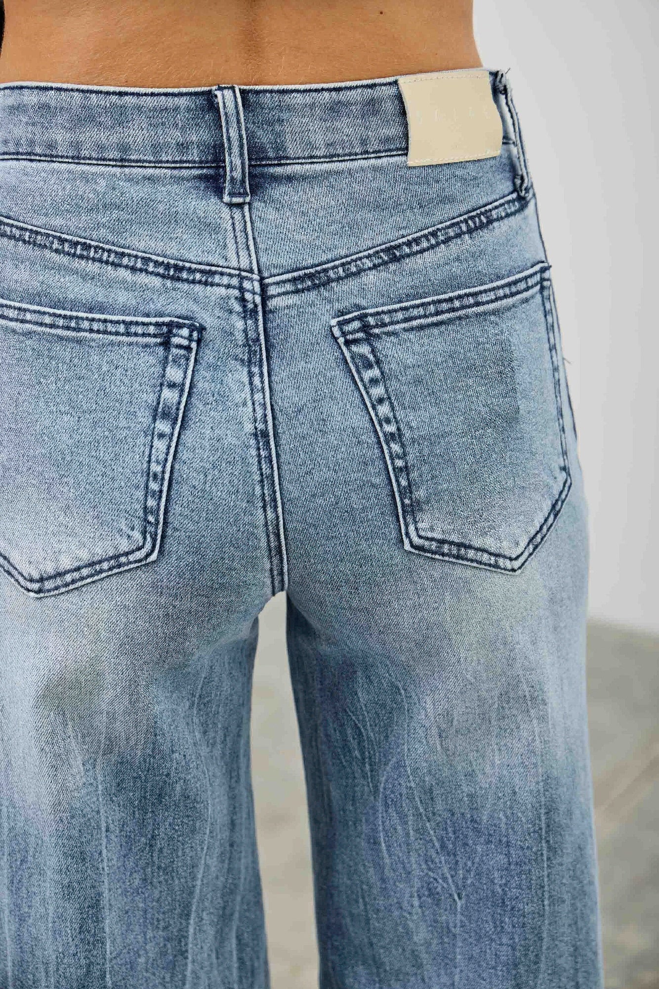 High-rise wide-leg jeans with contrast waistband patch and front pocket stitching