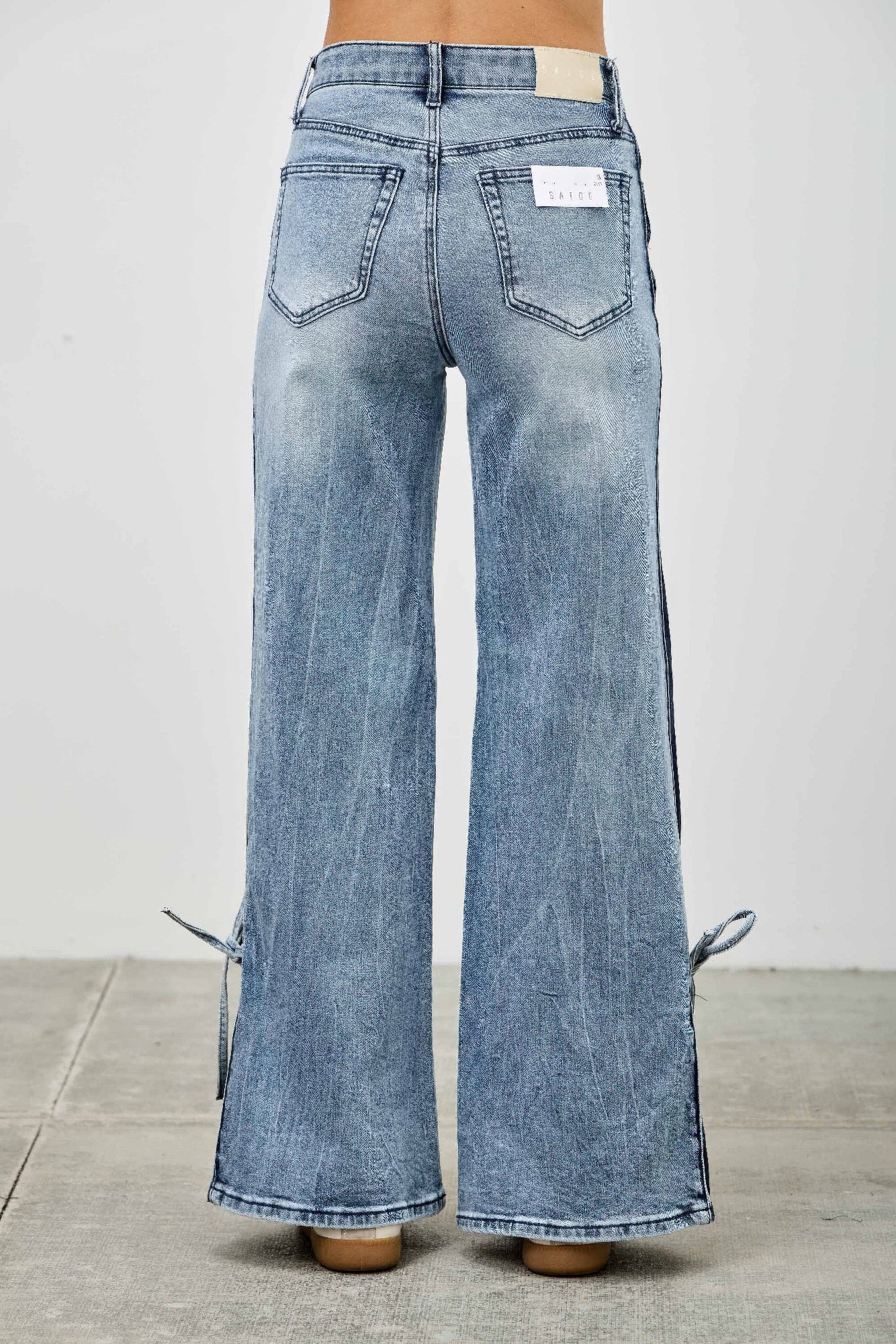 Back view wide-leg jeans in light wash, ribbon ties at sides, high rise