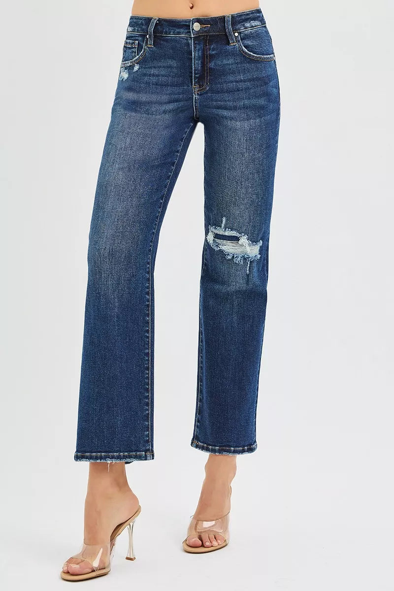 Dark blue high-rise crop slim straight jeans; knee patch and cuffed hem, side view