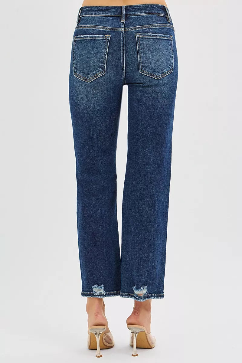 Dark blue high-rise crop slim straight jeans; back view with two pockets, knee rip