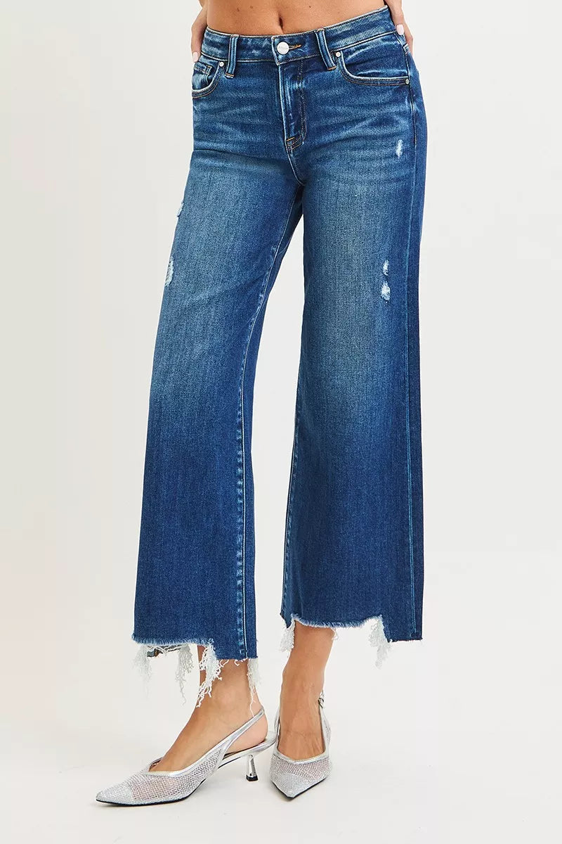 Dark blue wide-leg jeans, high-rise fit, distressed spots, frayed ankle hem