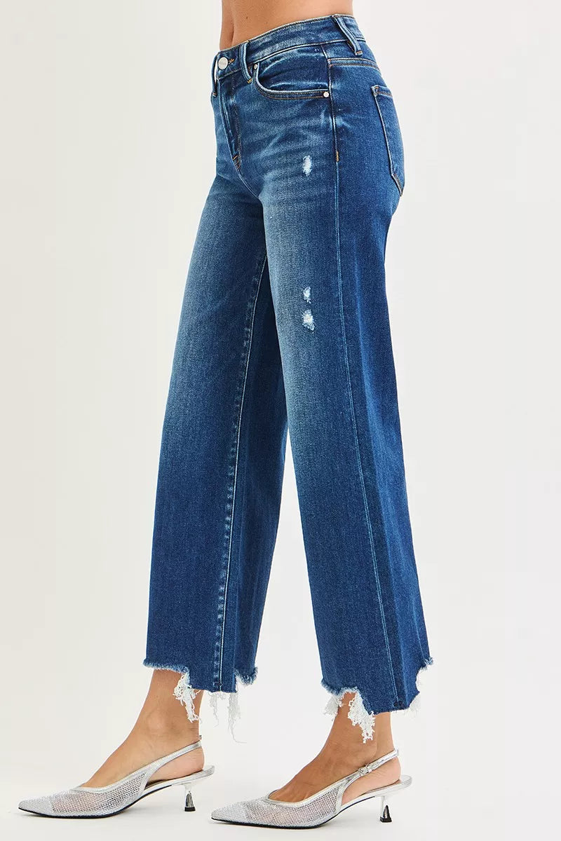 Side view dark blue high-rise wide-leg jeans with button closure and frayed hem