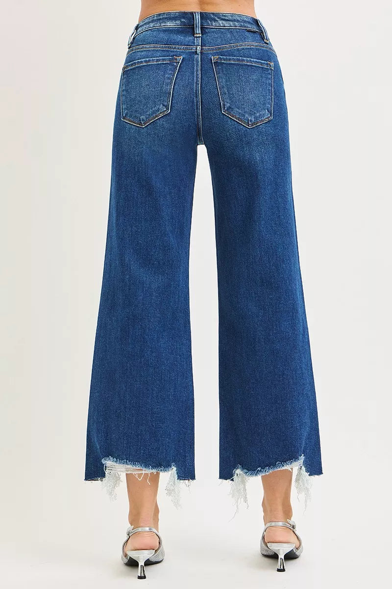 Back view dark blue wide-leg jeans with two back pockets and frayed bottom hem