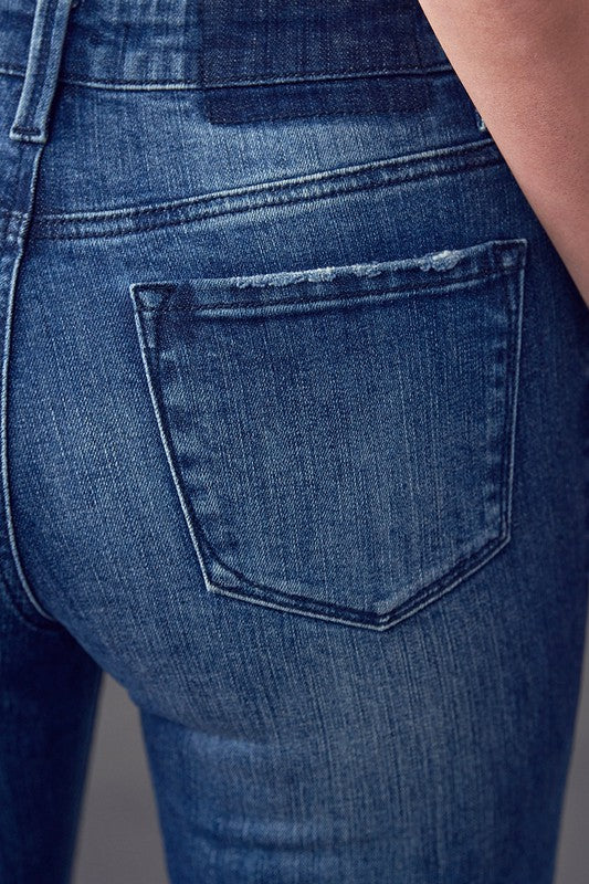 Dark wash denim jeans close-up of front pocket and curved pocket seams