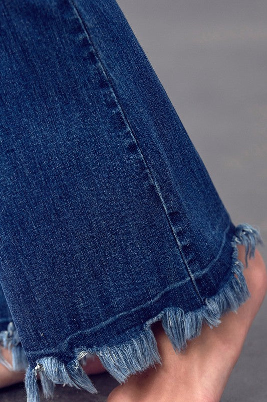Dark wash boot flare jeans close-up of frayed hem and step-down stitching