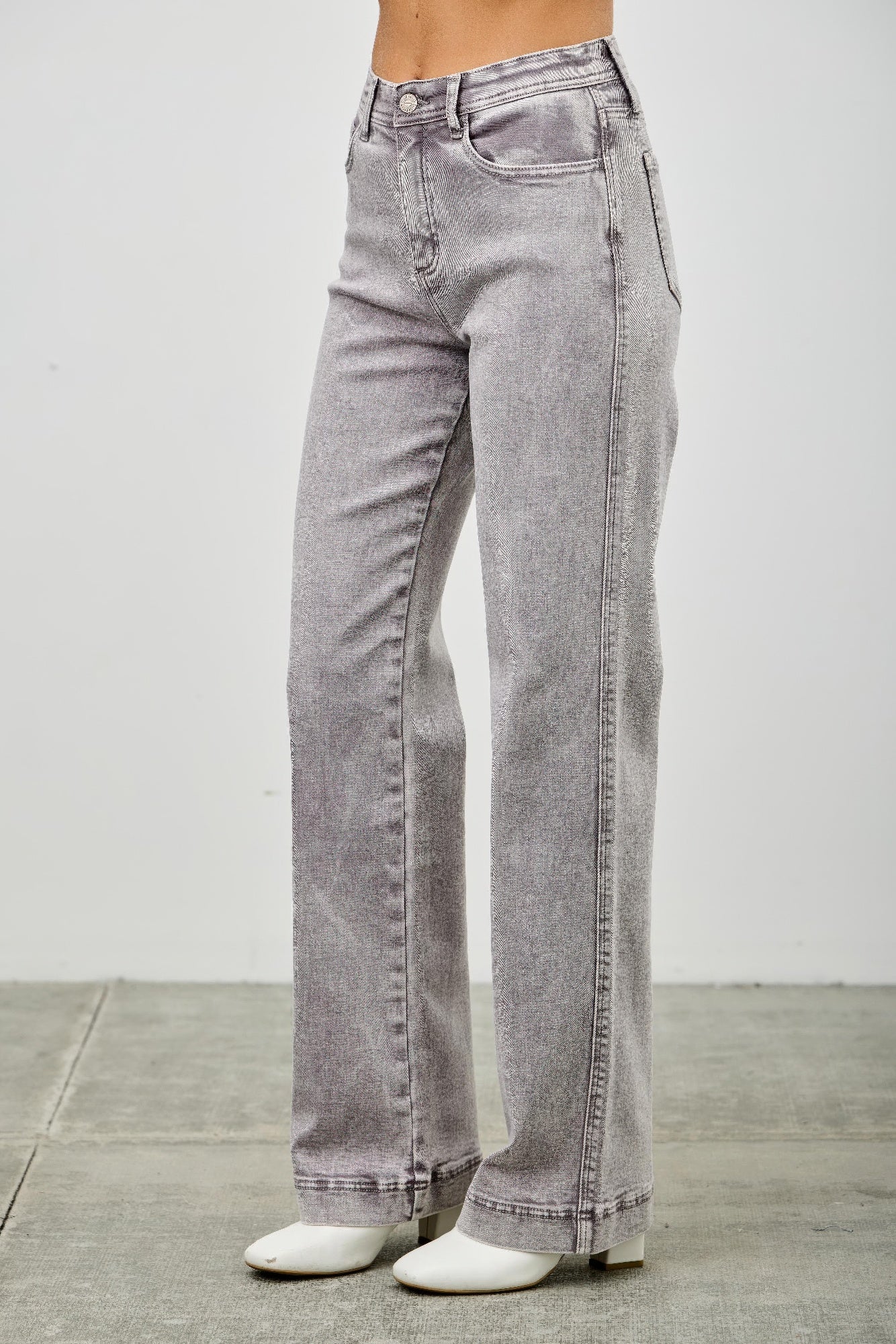 Light gray high rise straight-leg jeans, side view with front pocket and waistband detail.
