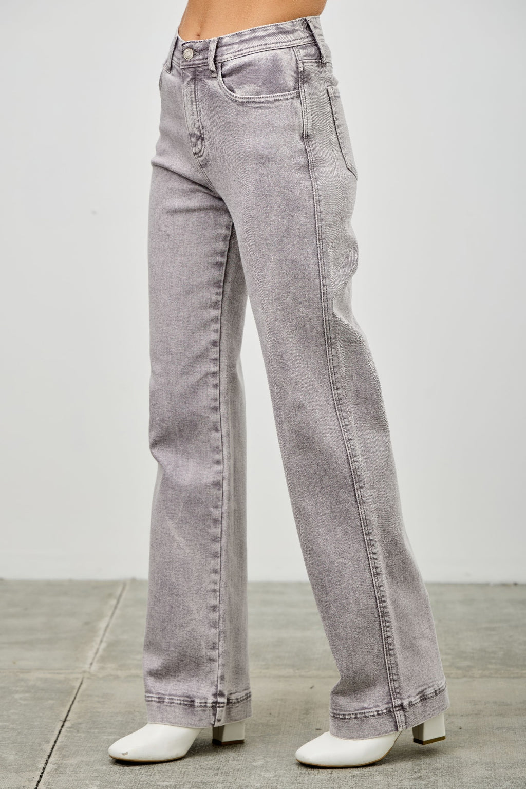 High rise jeans, light gray denim, back pockets and center seam detail from the side.
