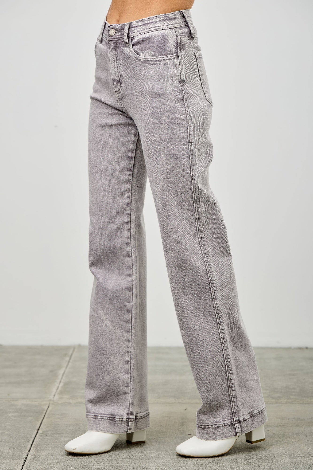 High rise jeans, light gray denim, back pockets and center seam detail from the side.