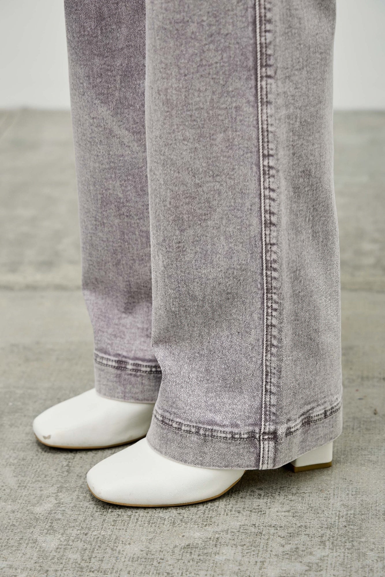 Light gray wide straight jean hem with cuff stitching and visible inseam seam detail.