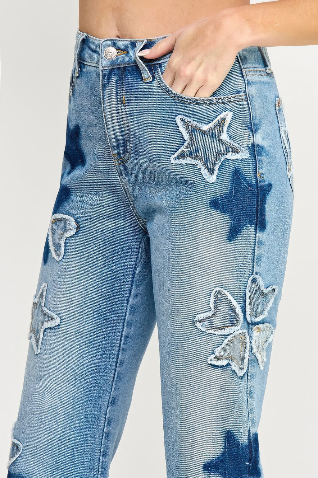 Close-up front: high-rise dad jeans with embroidered star and heart patch details