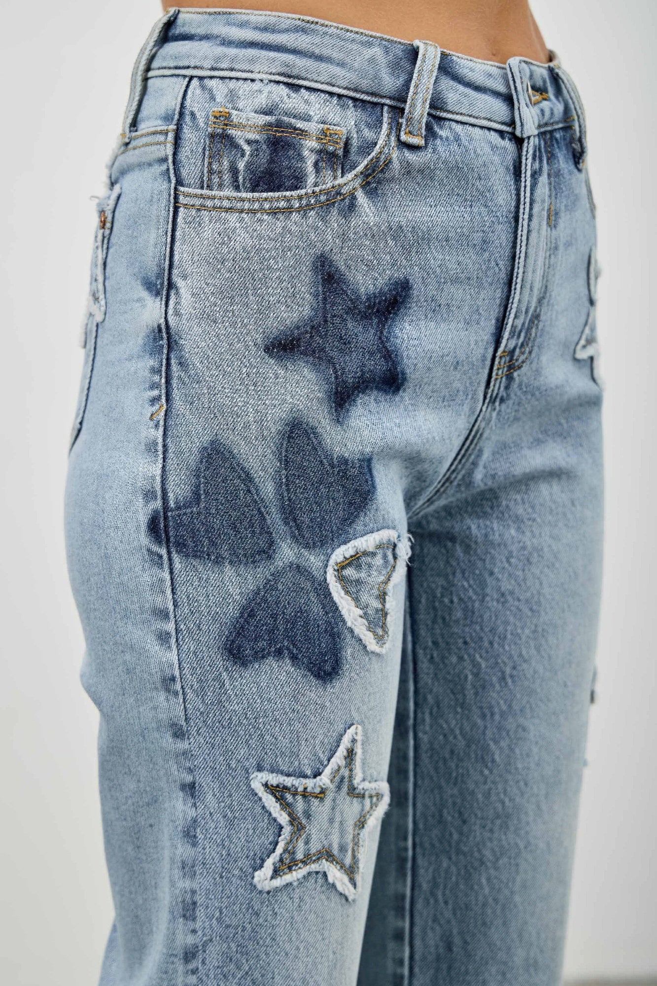 High-rise dad jeans with stitched star patches on the back pocket