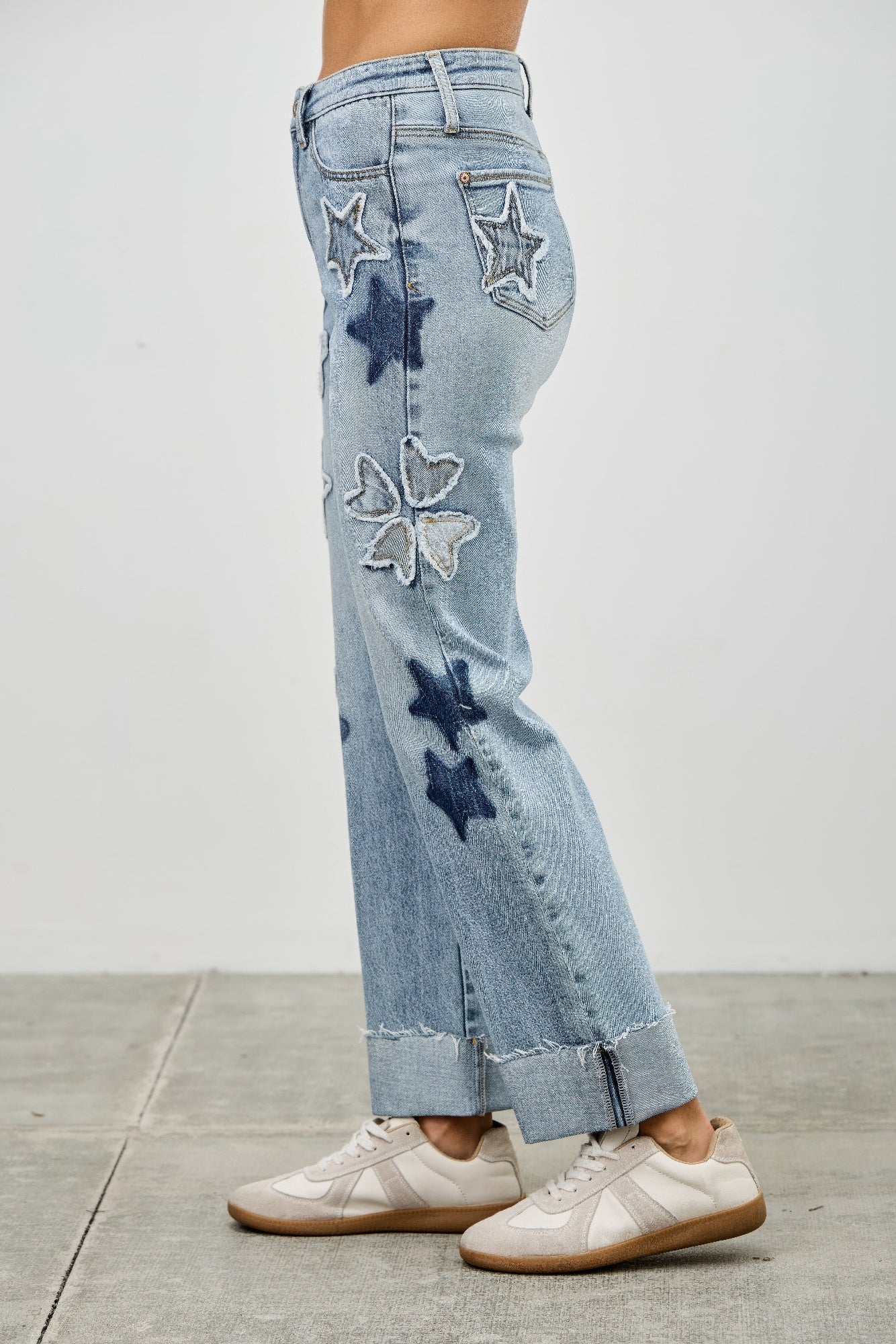 High-rise stretch dad jeans with star and heart applique patches on the leg