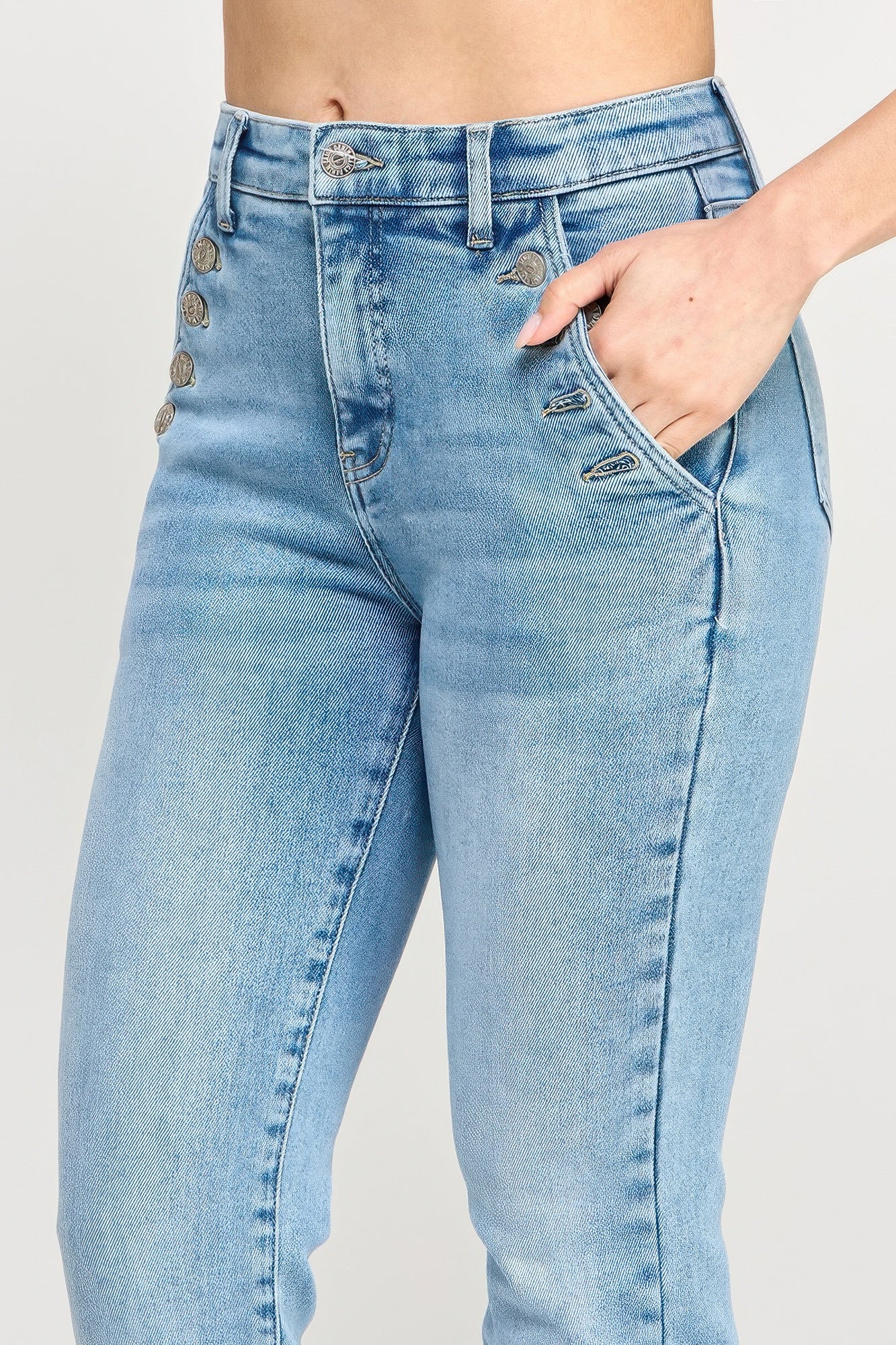 Close-up: high-rise straight button pocket jeans in light blue wash