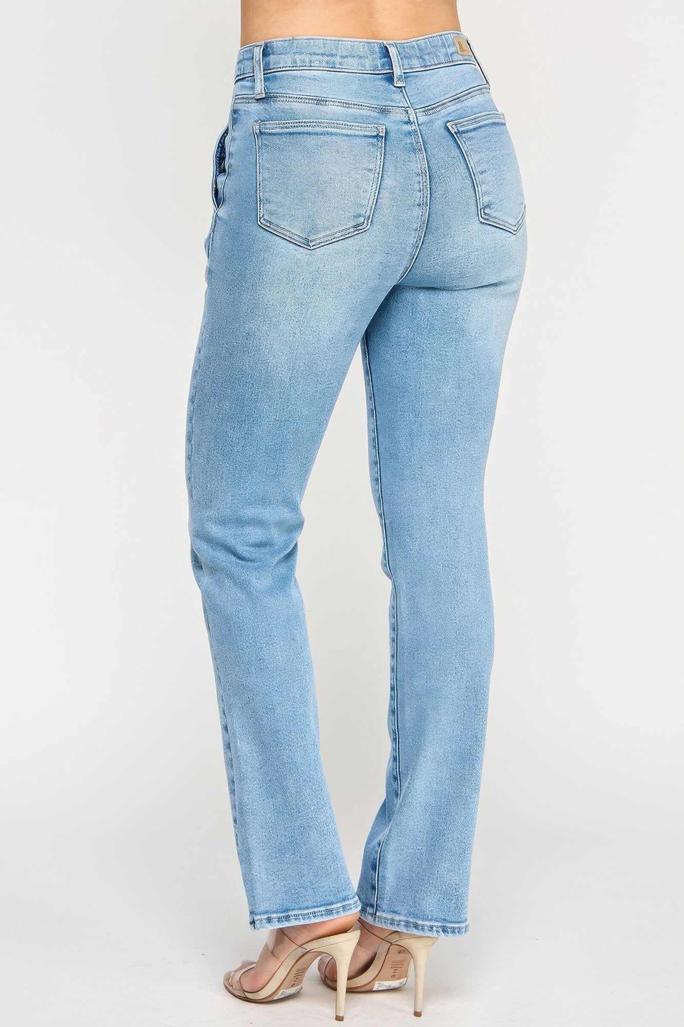Back view: high-rise straight jeans with back pockets, light blue wash