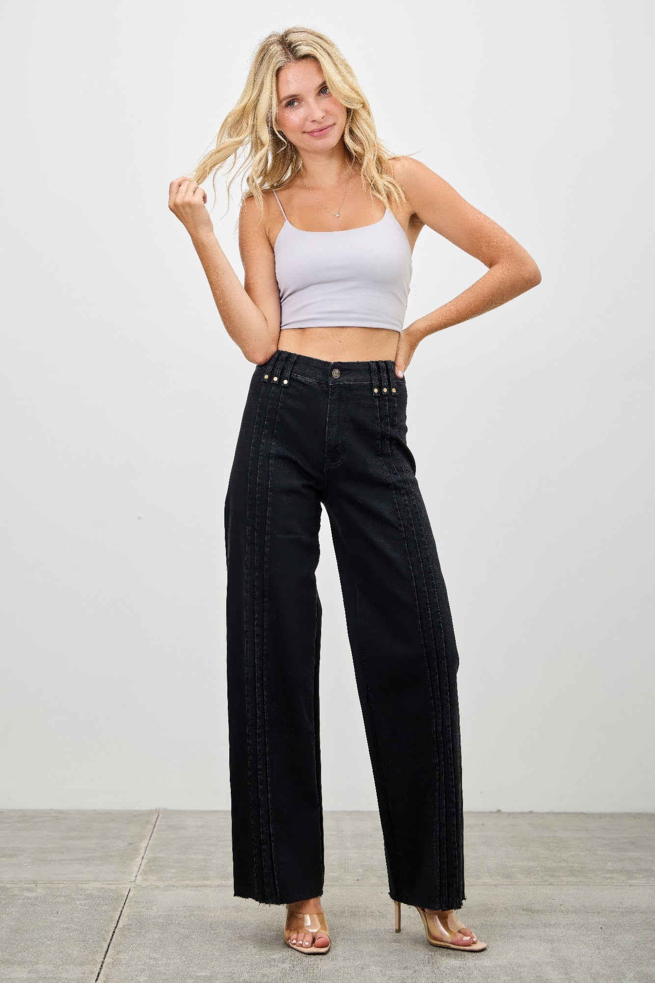 High-rise straight black jeans with studded waistband and vertical front seam panels