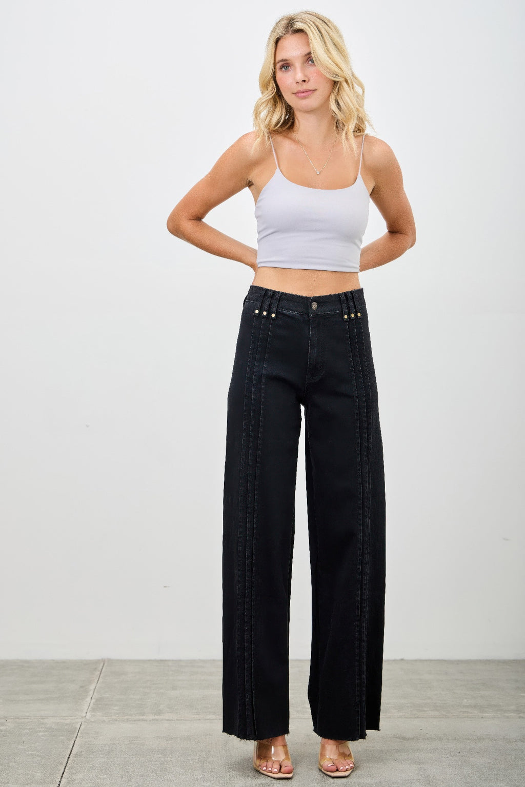 High-rise straight black jeans, dark denim, vertical front seam lines near pockets
