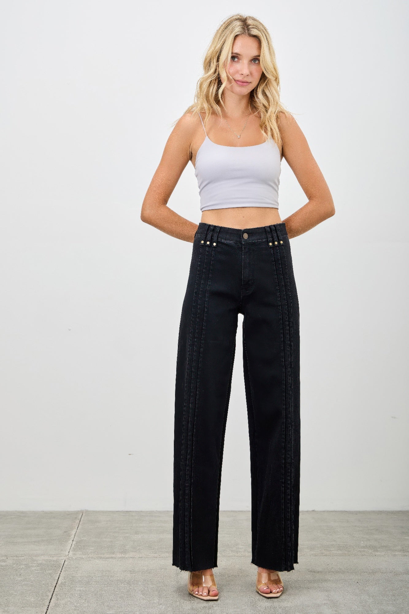 High-rise straight jeans in dark black denim with studded waistband and stitched front lines