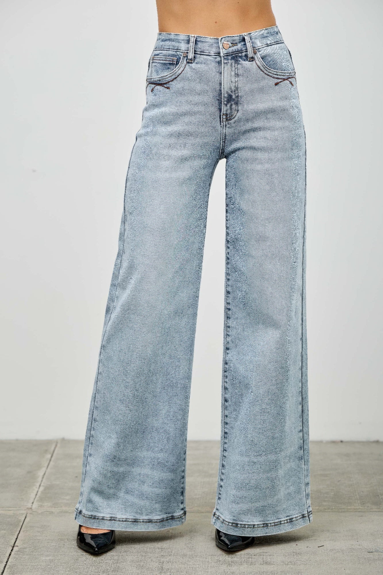 High rise wide-leg jeans front view, light blue denim with high waistband and button