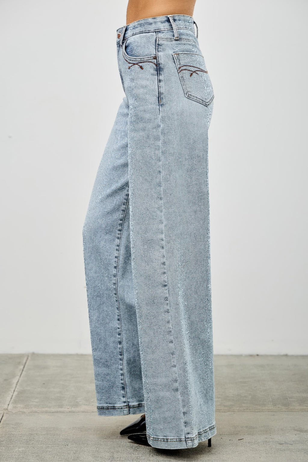 High rise wide-leg jeans rear close-up, light blue denim with back pocket detail