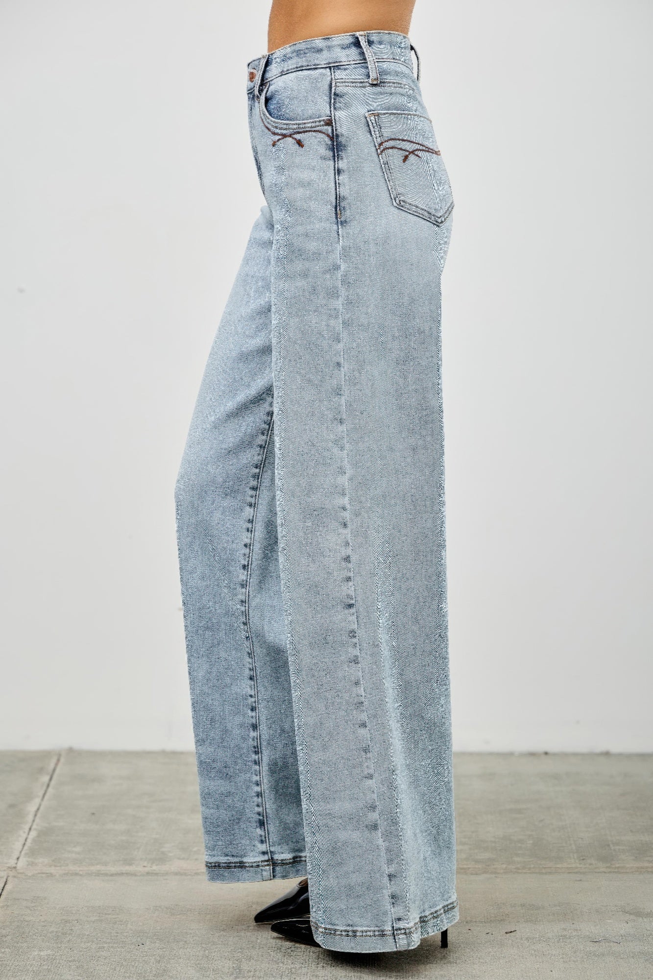 High rise wide-leg jeans rear close-up, light blue denim with back pocket detail