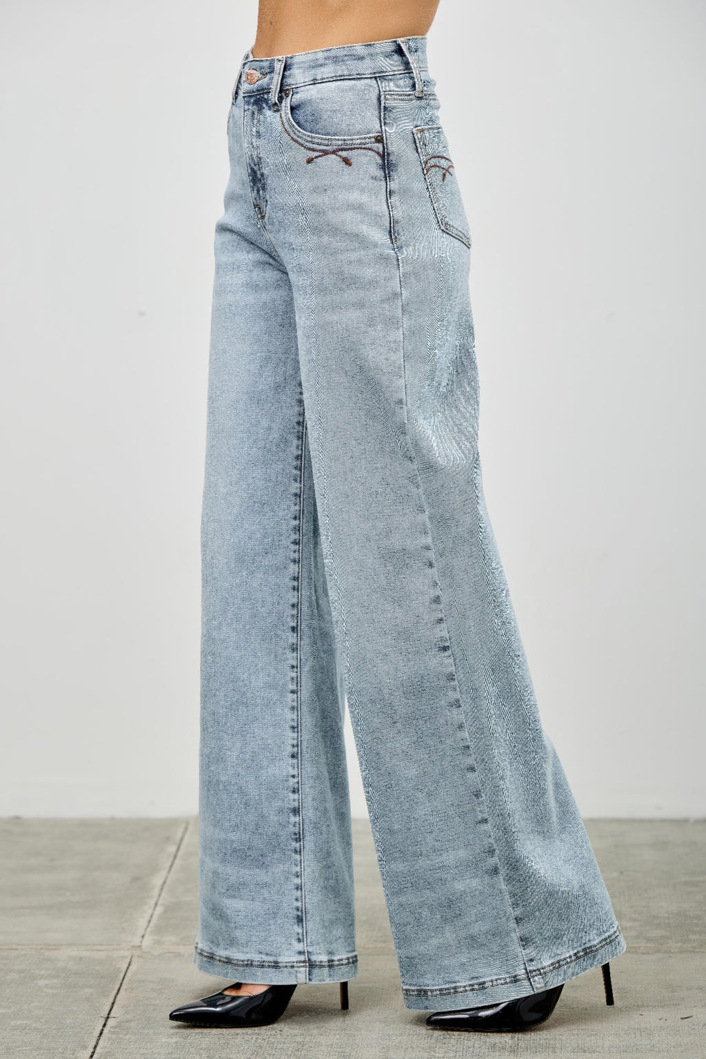High rise wide-leg jeans back close-up, light blue denim with back pocket and yoke