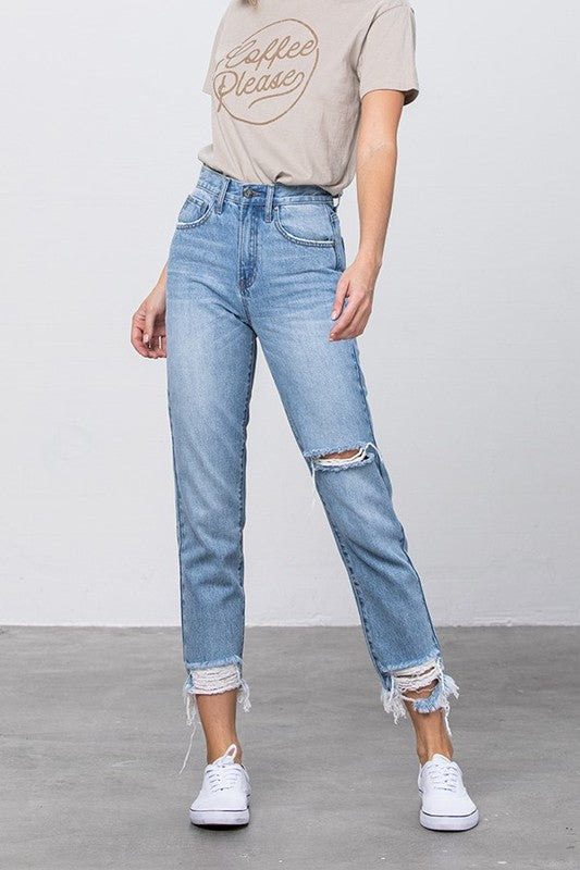 High-waist ripped jeans in medium wash with frayed tapered hems and knee rips