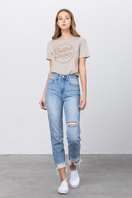 High-waist ripped tapered jeans, medium-wash denim with frayed cuffs at hem