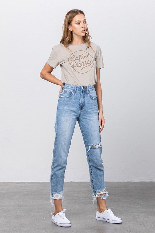 High-waist tapered jeans, medium wash denim with side knee rip and frayed hem