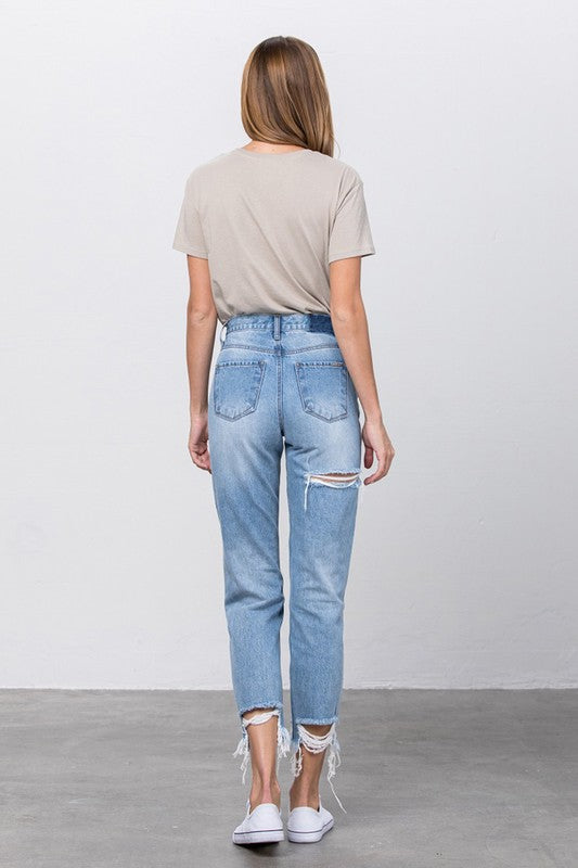 High-waist jeans back view in medium wash with ripped front panel and frayed hem