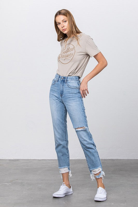High-waist tapered ripped jeans in medium wash with frayed ankle hem and cuff details
