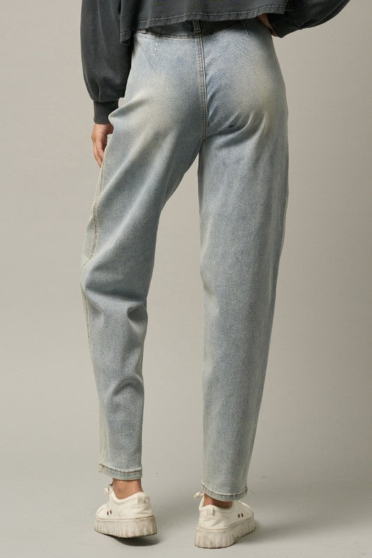 Light high-waisted balloon jeans, back view with center seams and cuffed hems