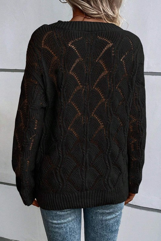 Black hollow-knit sweater back view with openwork knit pattern and ribbed hem