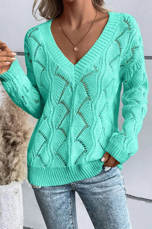 Green hollow-knit V-neck sweater with openwork pattern and ribbed waist hem