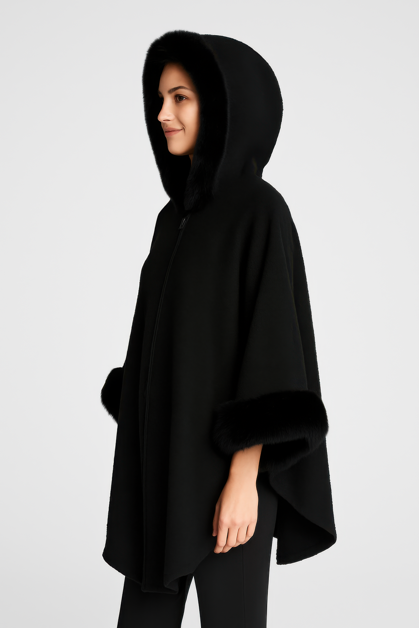 Black hooded cape side view with faux fur cuff details and front closure