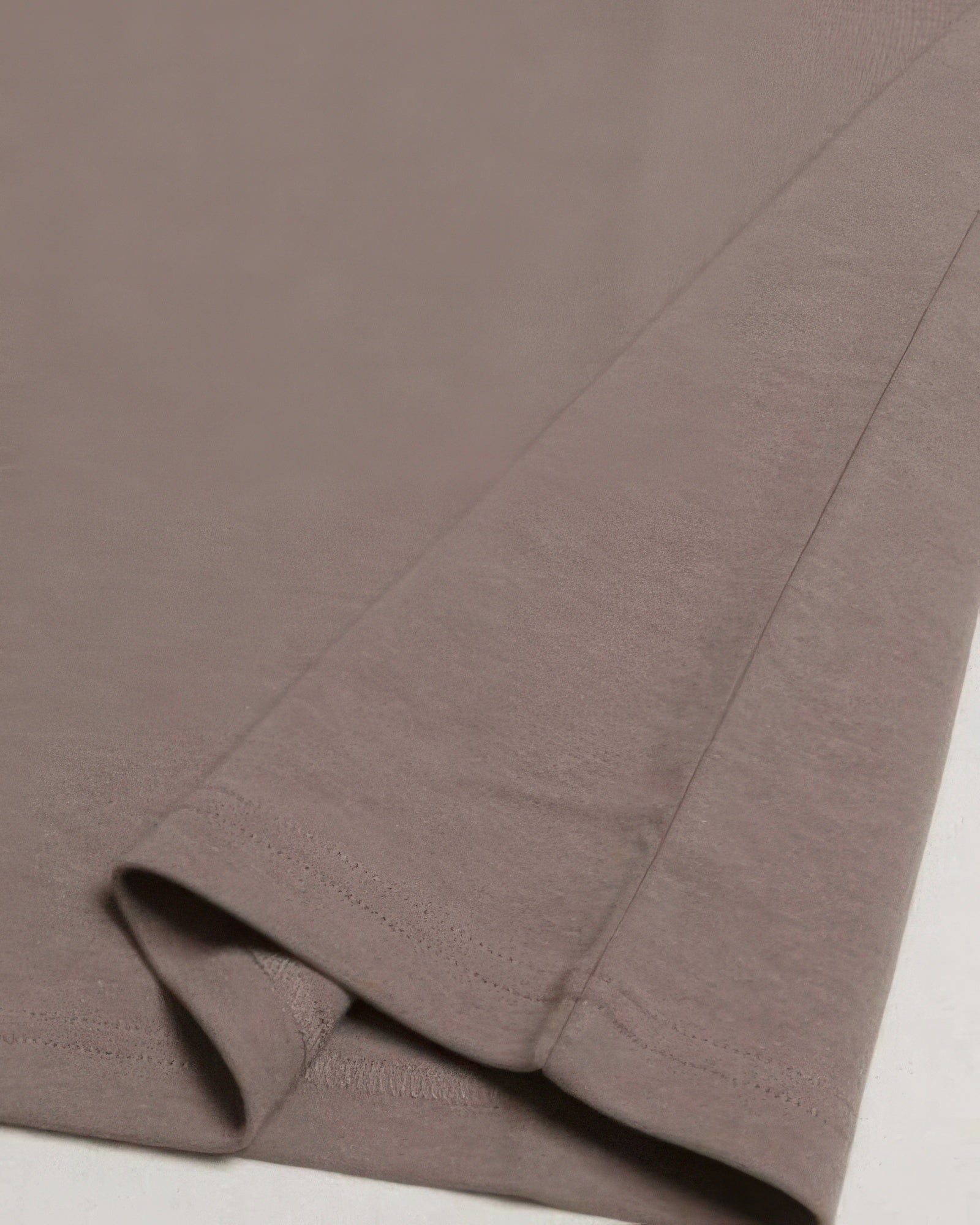 Taupe-brown crew tee fabric and side seam detail with double-stitched hem