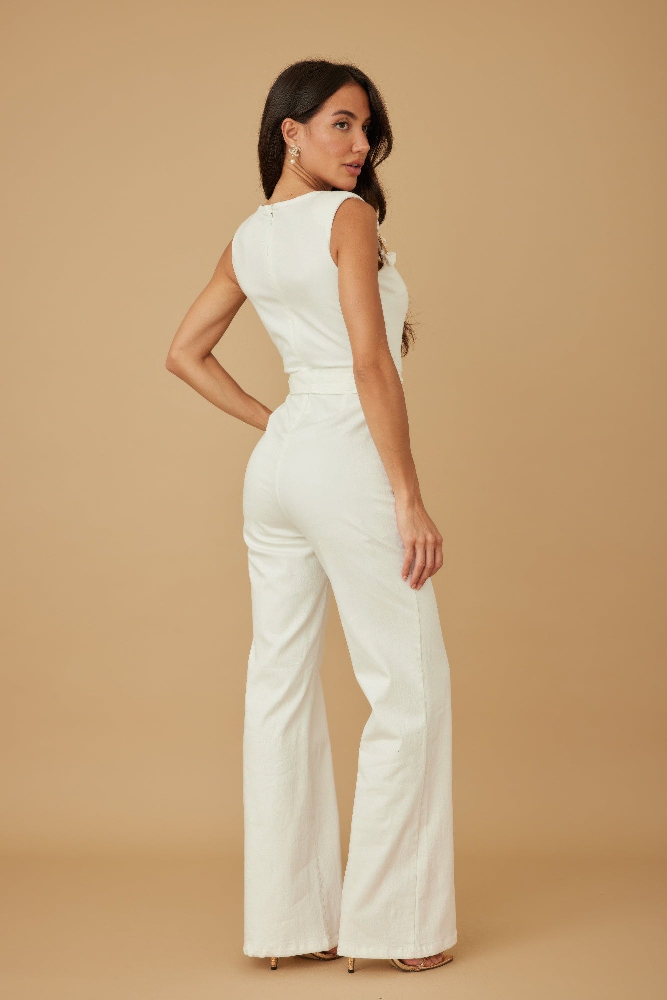 White strap jumpsuit side view with fitted waist, sash tie, and wide flared legs