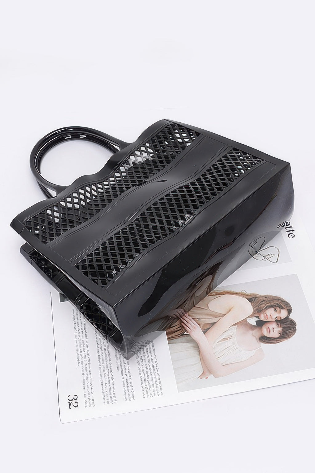 Black Jelly Tote Bag angled view with long lattice strap and front panel