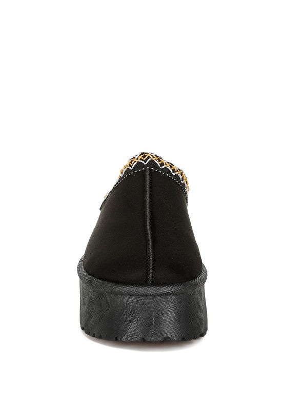 Black jester-trim platform slip-on shoe, side heel view