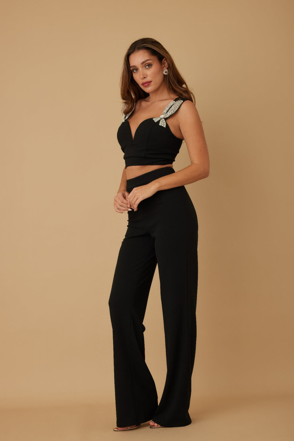 Black crop top set with jeweled bow straps and wide-leg trousers