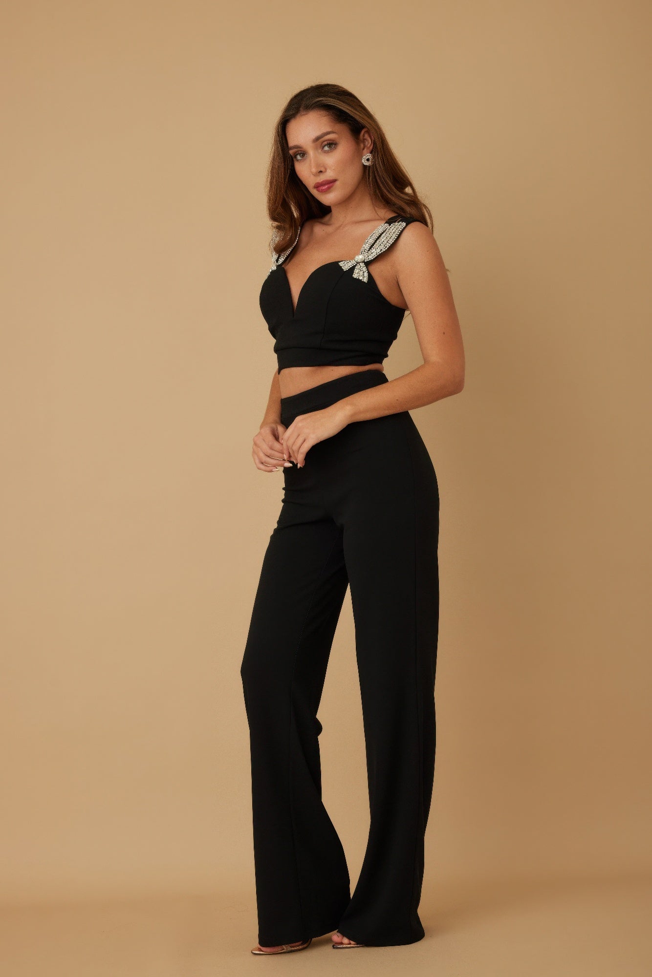 Black crop top set with jeweled bow straps and wide-leg trousers