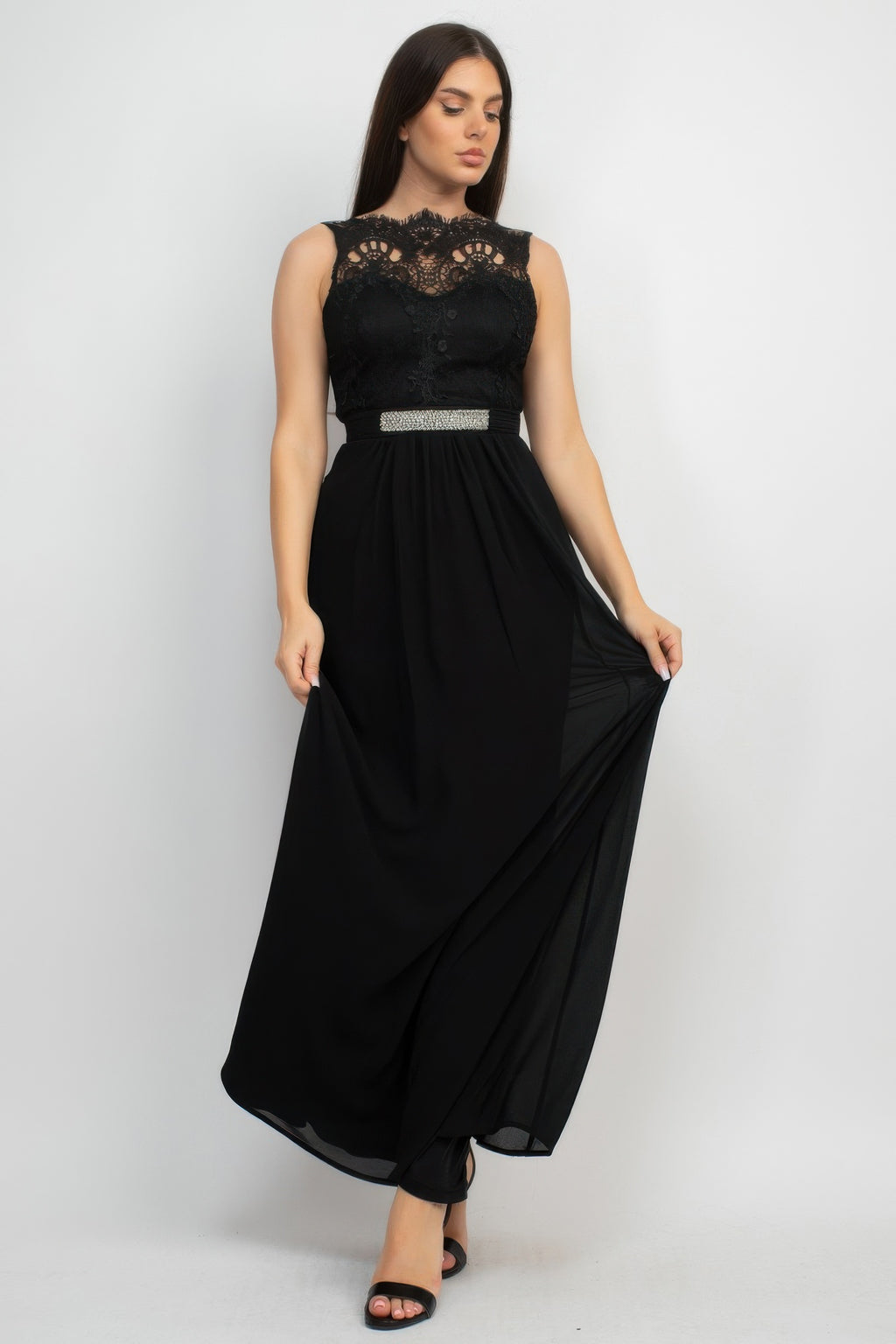 Black lace maxi dress with jewel waist belt and flowing skirt, side view