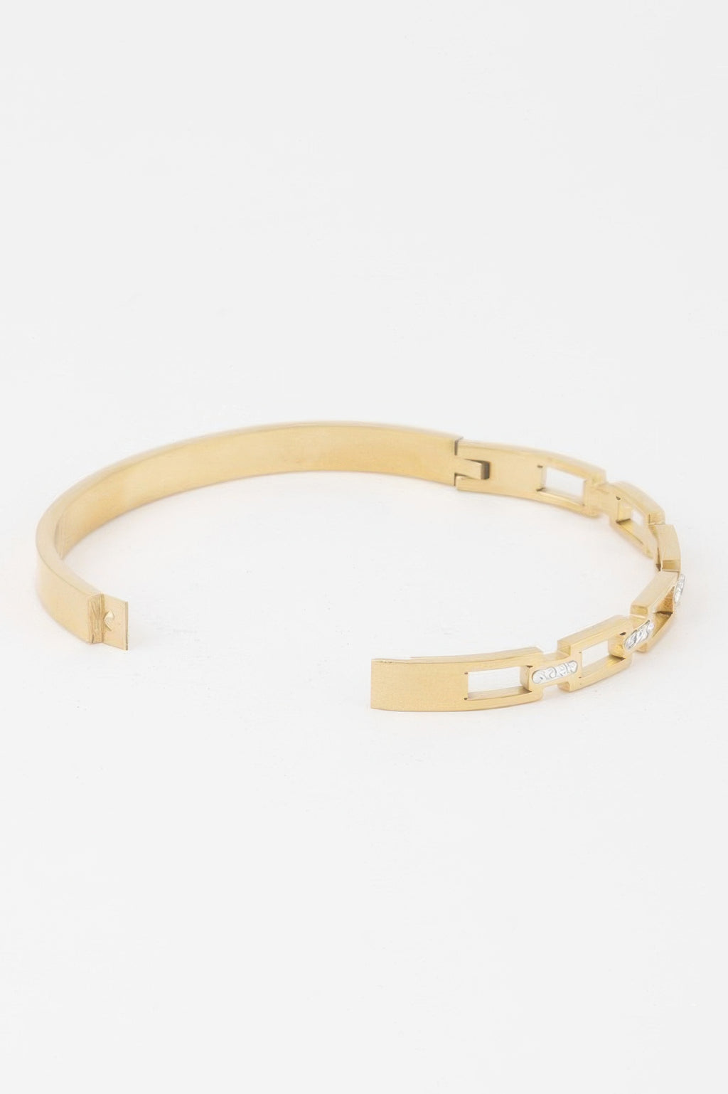 Gold-tone bracelet detail with jeweled clasp and rectangular chain links