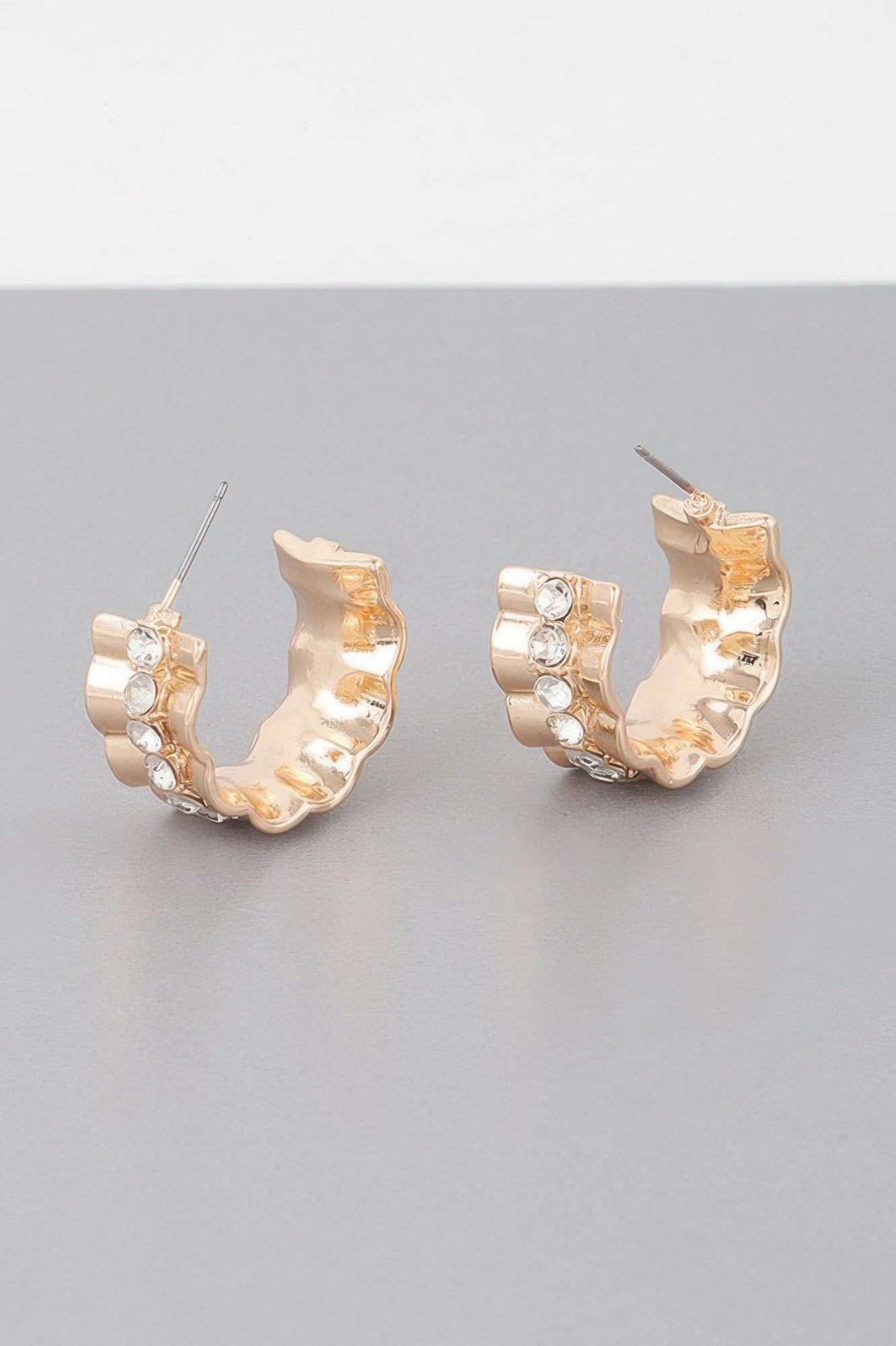 Gold tone jeweled lace hoop earrings, front view with clear round stones