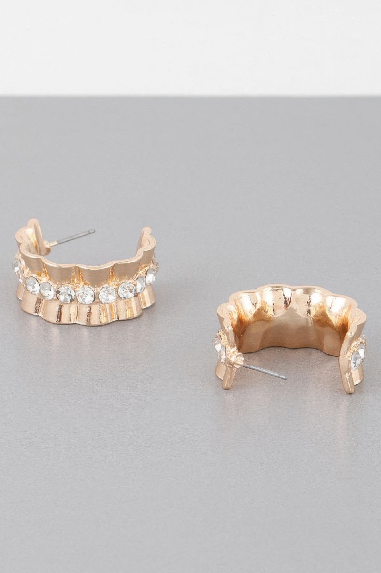 Gold tone jeweled lace hoop earrings, side view showing clasp and stone row